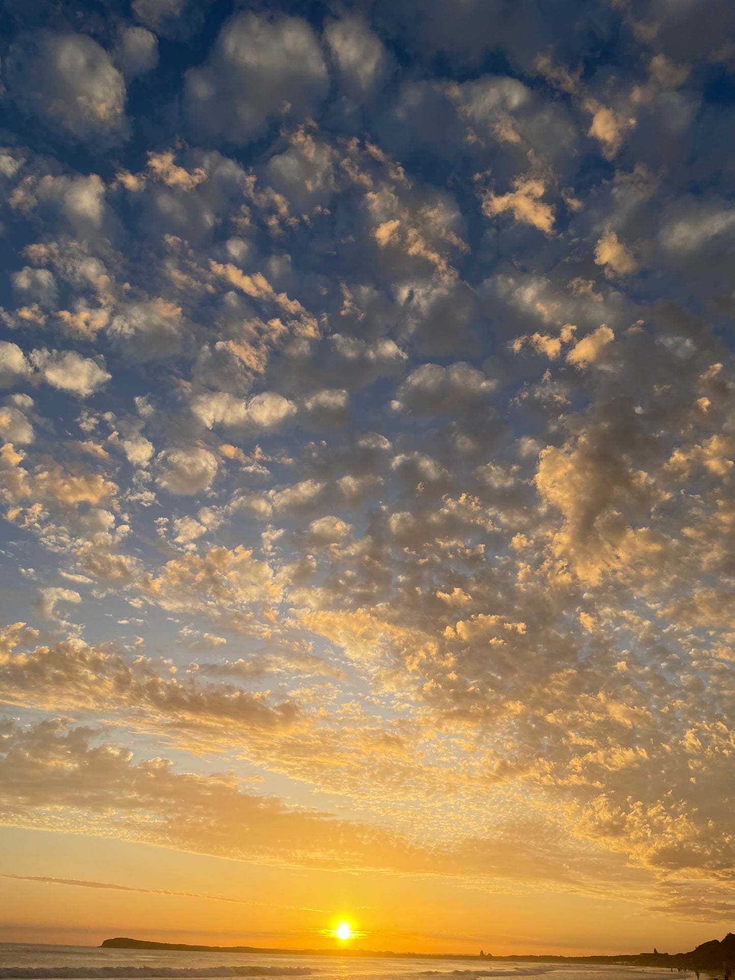 A high quality photograph of an Aussie night sunset, showcasing the stunning contrast between the vibrant sun and the blue sky. The image captures the beauty of Australia's coastal landscape. Printed on premium material for a refined and elegant finish.