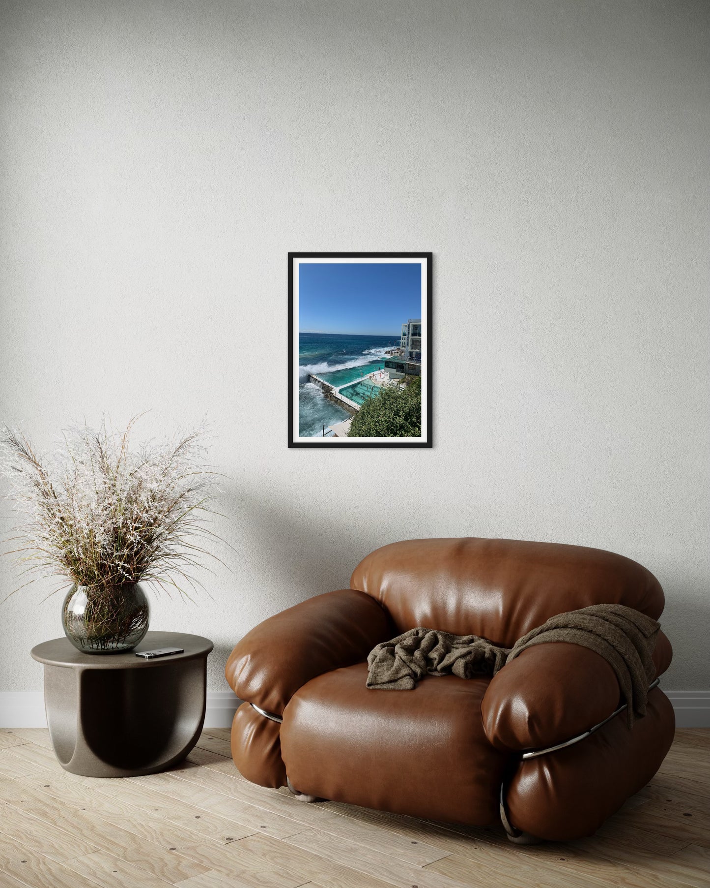 A high-quality photograph of the iconic Icebergs Pool at Bondi Beach, New South Wales (NSW), showcasing the stunning contrast between the vibrant blue waters of the pool and the crashing waves of the ocean. The image captures the beauty of the pools set against the rugged coastal landscape, with the clear sky and beach in the background. Printed on premium material for a refined and elegant finish, this photograph is a sophisticated depiction of one of Australia's most famous swimming spots.