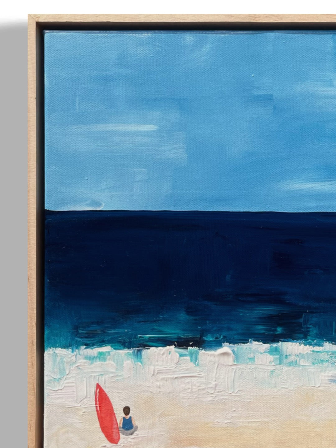 Original hand painted acrylic painting on canvas of a surfer in front of the deep blue ocean. The scene captures a surfer by his surf board, with golden sand adding warmth to the composition. The deep blues of the water contrast with the soft, warm tones of the shore close-up.